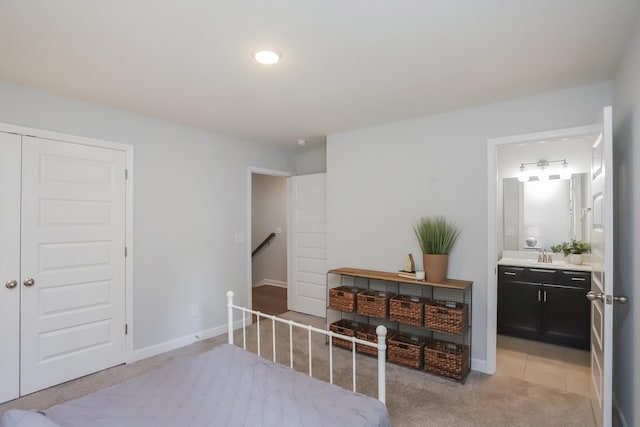 2804 Sonoma Way, Columbia, TN 38401 - bedroom featuring a sink, a closet, ensuite bathroom, baseboards, and light colored carpet