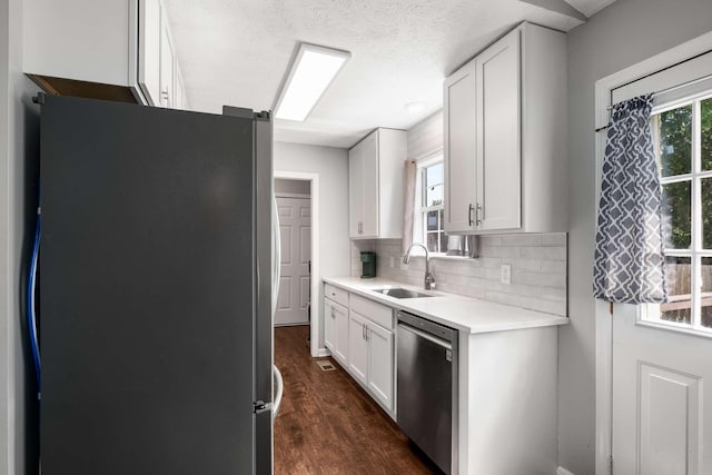 5000 Trailwater Dr, Antioch, TN 37013 - kitchen with appliances with stainless steel finishes, a sink, white cabinets, dark wood finished floors, and tasteful backsplash