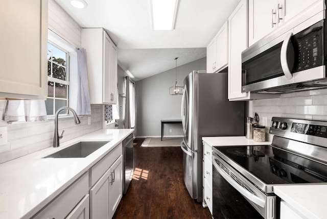 5000 Trailwater Dr, Antioch, TN 37013 - kitchen with appliances with stainless steel finishes, a sink, decorative backsplash, light countertops, and vaulted ceiling