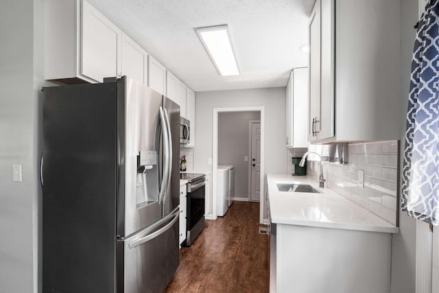 5000 Trailwater Dr, Antioch, TN 37013 - kitchen featuring appliances with stainless steel finishes, a sink, light countertops, backsplash, and white cabinets