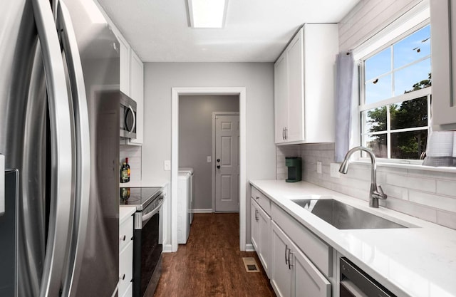 5000 Trailwater Dr, Antioch, TN 37013 - kitchen featuring stainless steel appliances, a sink, decorative backsplash, and dark wood-style floors