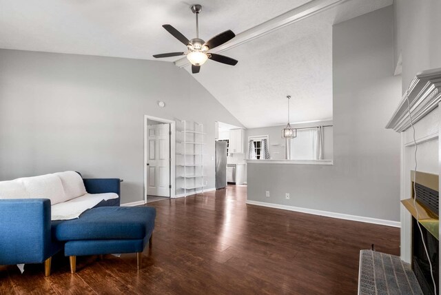 5000 Trailwater Dr, Antioch, TN 37013 - living area featuring a ceiling fan, high vaulted ceiling, baseboards, dark wood-type flooring, and a fireplace with flush hearth