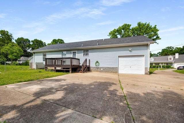 5000 Trailwater Dr, Antioch, TN 37013 - rear view of property featuring a wooden deck, an attached garage, driveway, a lawn, and a shingled roof