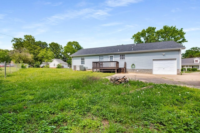 5000 Trailwater Dr, Antioch, TN 37013 - rear view of house featuring a wooden deck, concrete driveway, an attached garage, and fence