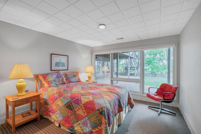 bedroom with carpet, baseboards, multiple windows, and access to exterior