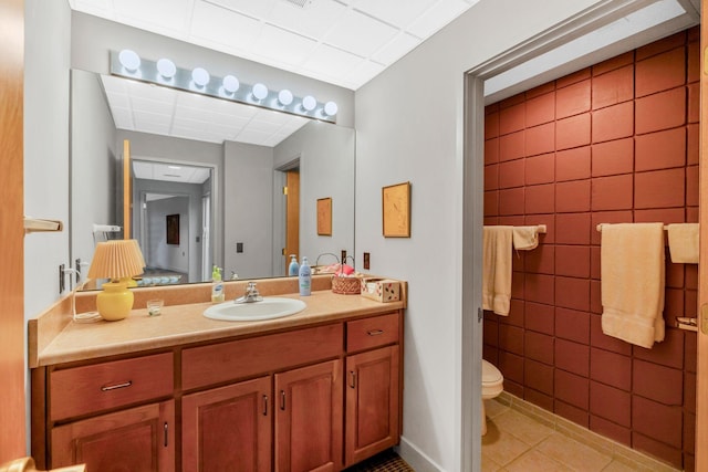 bathroom with tile patterned flooring, toilet, and vanity
