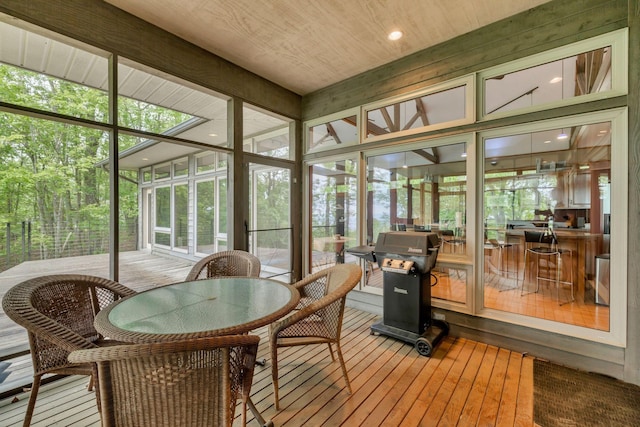 sunroom / solarium featuring outdoor dining area and plenty of natural light