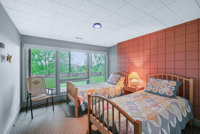 bedroom with carpet flooring, multiple windows, visible vents, and baseboards