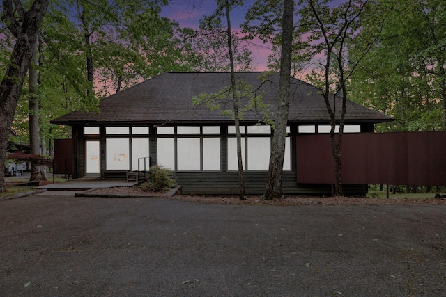 view of front facade with roof with shingles