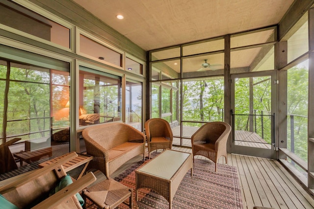 sunroom with an outdoor living space and a ceiling fan