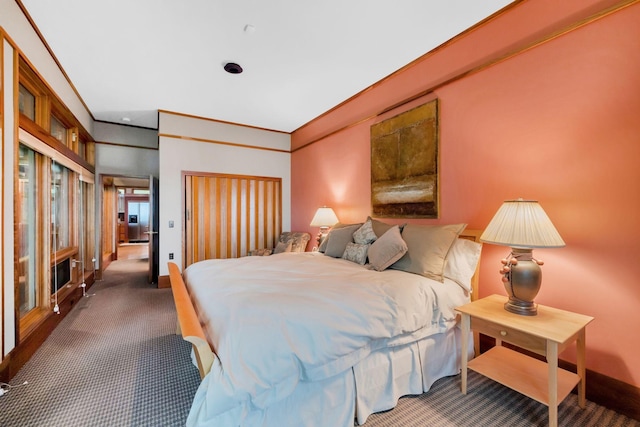 bedroom featuring baseboards, crown molding, and carpet floors