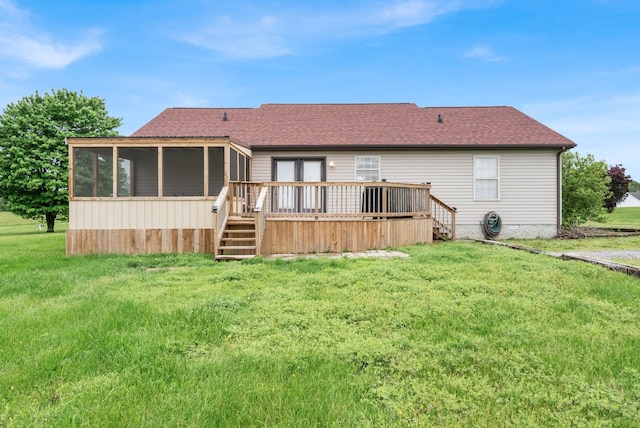 rear view of property featuring a sunroom, a deck, a lawn, a shingled roof, and stairs