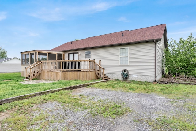 back of property with a sunroom, a shingled roof, stairway, and a wooden deck