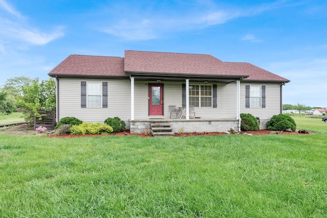 single story home with a porch, roof with shingles, and a front yard