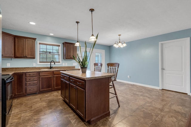kitchen featuring a center island, decorative light fixtures, a breakfast bar, a sink, and black range with electric cooktop