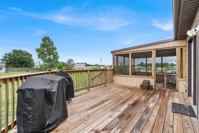 wooden deck featuring grilling area and a sunroom