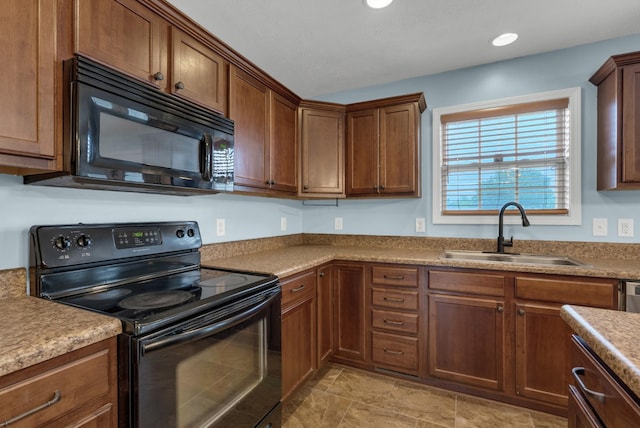 kitchen with recessed lighting, black appliances, and a sink