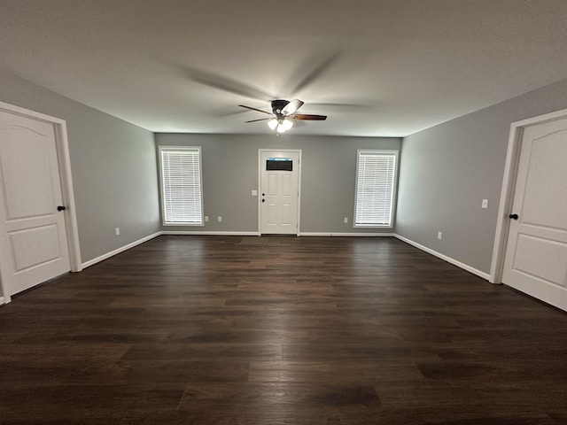 unfurnished living room featuring ceiling fan, baseboards, and plenty of natural light