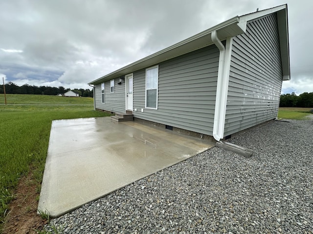 back of house featuring a patio area, crawl space, a lawn, and entry steps
