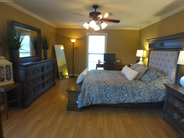 bedroom with crown molding, baseboards, a ceiling fan, and wood finished floors