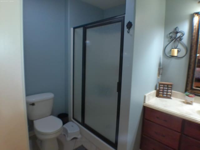 full bath with a stall shower, vanity, and toilet