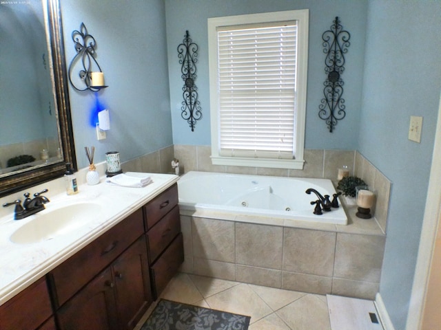 full bathroom with tile patterned floors, a jetted tub, and vanity