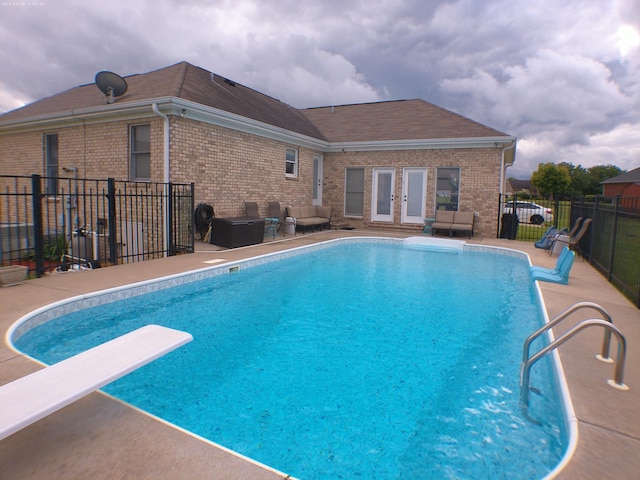 view of swimming pool featuring fence, a patio area, french doors, a fenced in pool, and outdoor lounge area