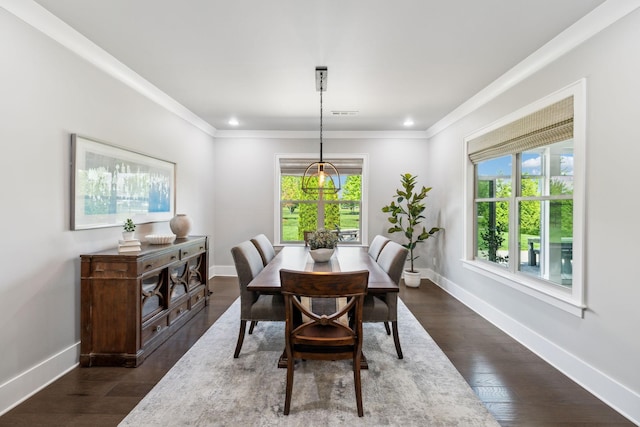 dining space with crown molding, baseboards, and dark wood-style floors