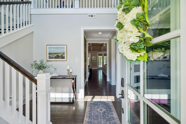foyer entrance featuring stairs, french doors, visible vents, and wood finished floors