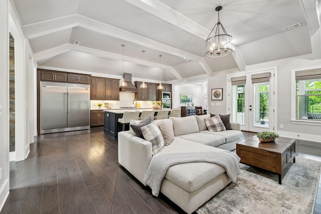 living room with a chandelier, visible vents, lofted ceiling with beams, and dark wood-style floors