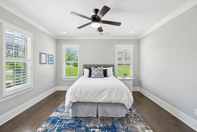 bedroom featuring multiple windows, ornamental molding, and dark wood-type flooring