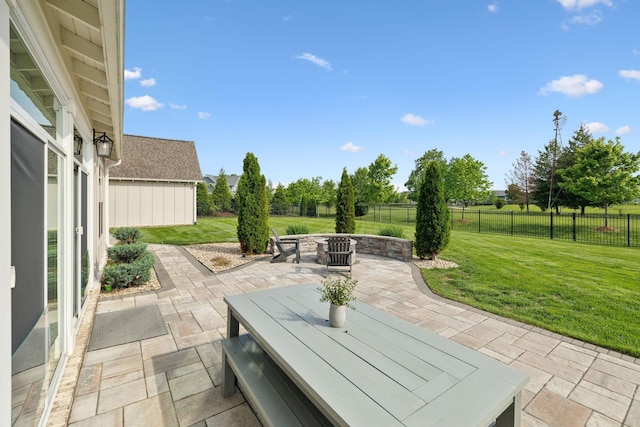 view of patio featuring an outdoor fire pit and fence