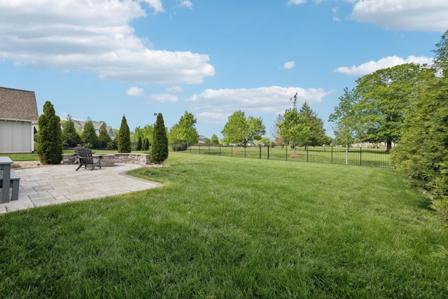 view of yard featuring an outdoor fire pit, a patio area, and fence