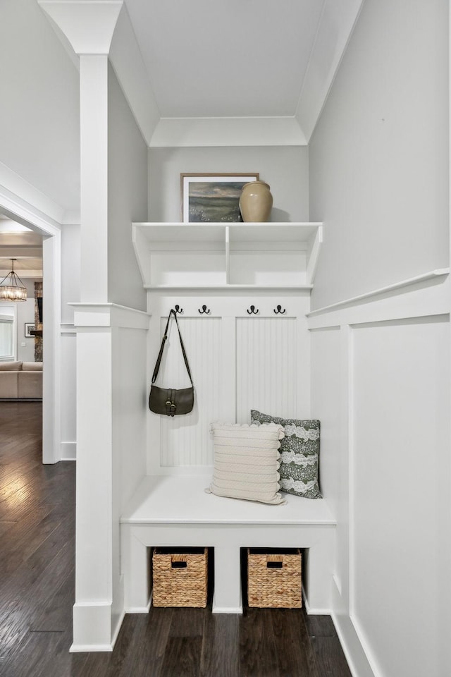 mudroom with dark wood-style flooring and wainscoting