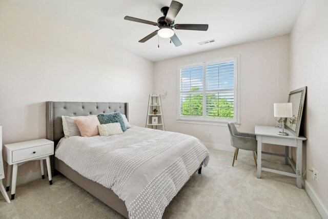 bedroom featuring visible vents, baseboards, a ceiling fan, and light carpet