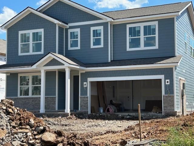 123 W Cassa Way, Mount Juliet, TN 37122 - view of front of house with a porch, a garage, and stone siding