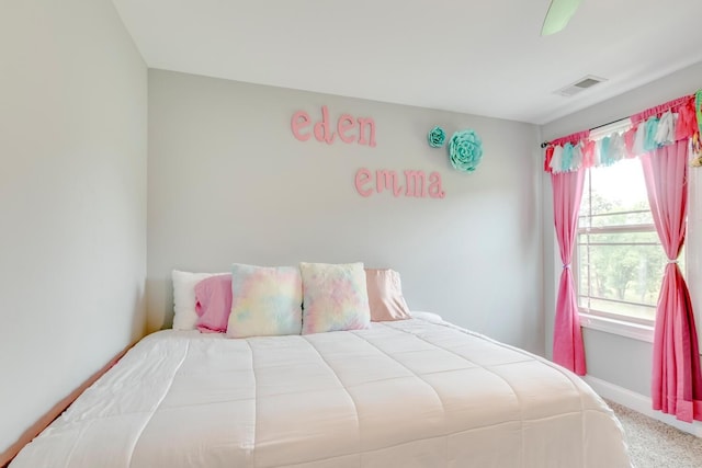 carpeted bedroom with ceiling fan, baseboards, and visible vents
