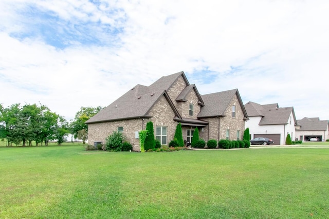 view of front of property with a front lawn, brick siding, and roof with shingles