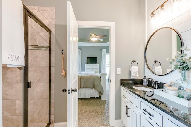 ensuite bathroom with vanity, a shower stall, ensuite bath, and a ceiling fan