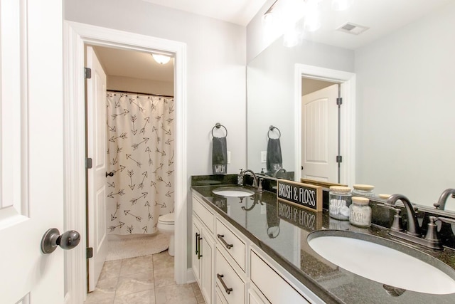full bath featuring double vanity, toilet, visible vents, and a sink