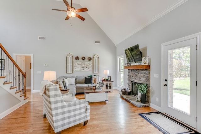 living area featuring a healthy amount of sunlight, ceiling fan, high vaulted ceiling, and visible vents