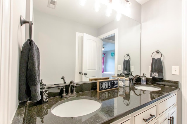 bathroom featuring a sink, double vanity, and visible vents
