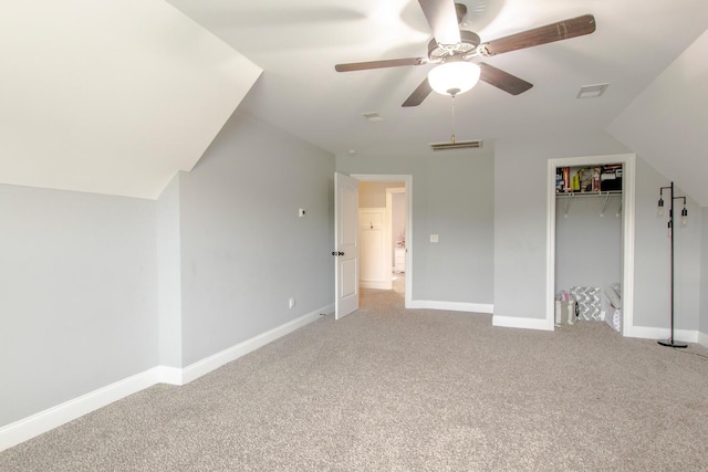 additional living space with light colored carpet, visible vents, baseboards, and ceiling fan