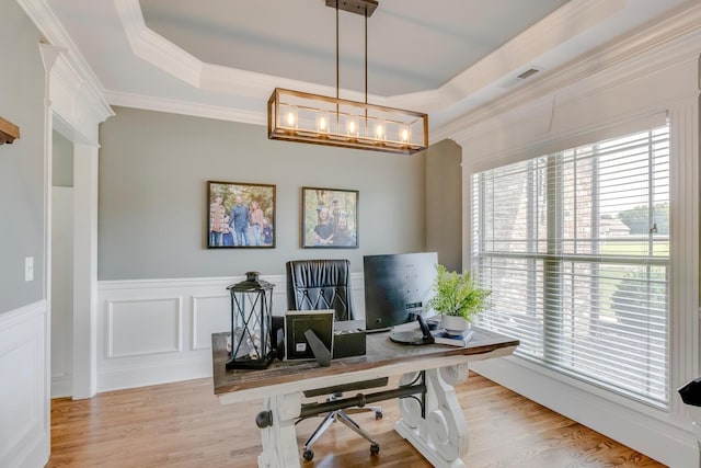 office featuring a raised ceiling, crown molding, and plenty of natural light