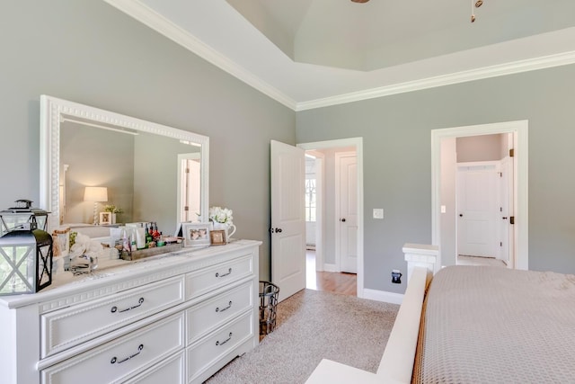 bedroom featuring crown molding, light carpet, and baseboards