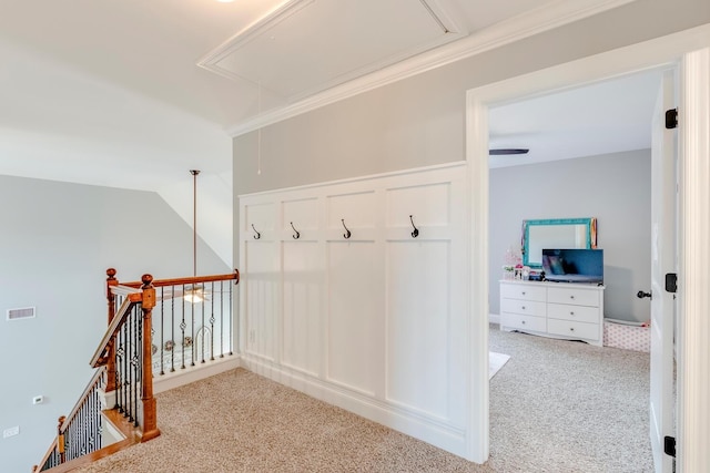 mudroom with attic access, carpet, and visible vents