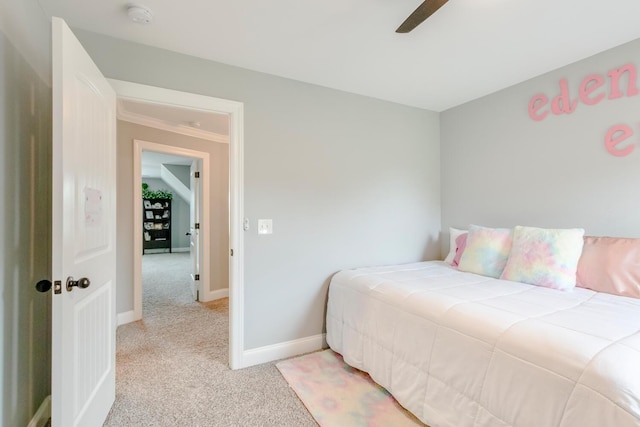 bedroom with baseboards, light carpet, and ceiling fan