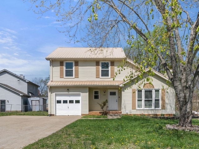 traditional home with metal roof, a front yard, driveway, and an attached garage