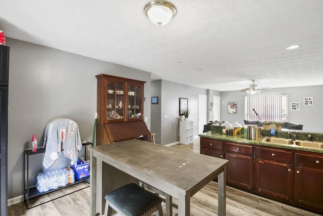 119 Sleepy Hollow Dr, Springfield, TN 37172 - kitchen with a sink, light wood-type flooring, reddish brown cabinets, ceiling fan, and baseboards