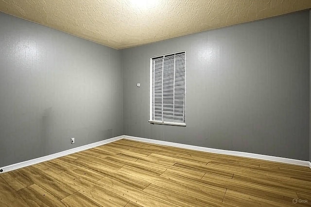 119 Sleepy Hollow Dr, Springfield, TN 37172 - unfurnished room with wood finished floors, a heating unit, a textured ceiling, and baseboards